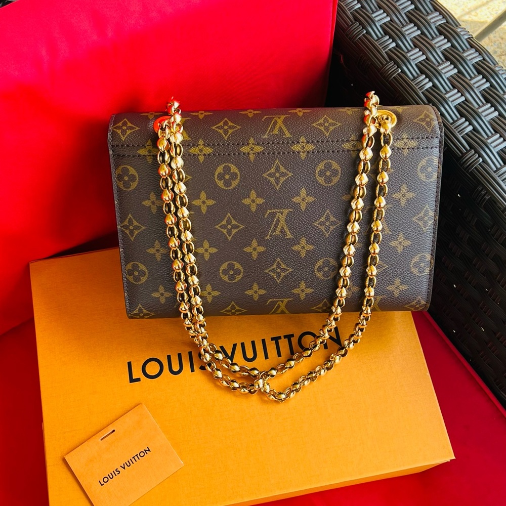 Authentic Louis Vuitton Victoire  shoulder/crossbody bag.